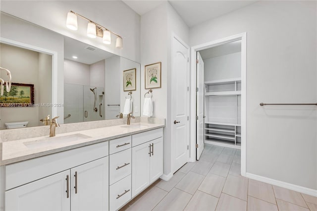 bathroom featuring tile patterned flooring, vanity, toilet, and an enclosed shower