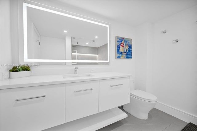 bathroom featuring tile patterned floors, vanity, and toilet