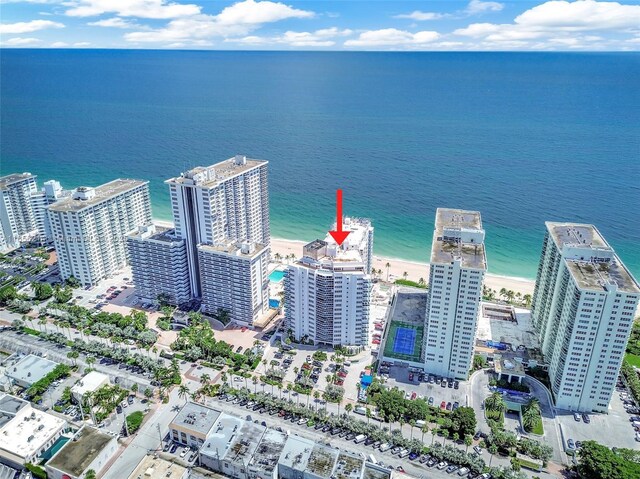 birds eye view of property with a beach view and a water view