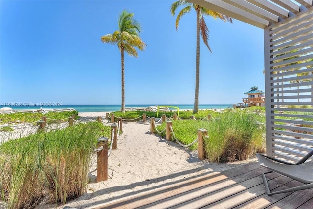 surrounding community featuring a view of the beach and a water view