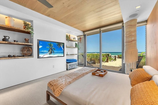 bedroom with wooden ceiling, access to outside, carpet floors, and expansive windows