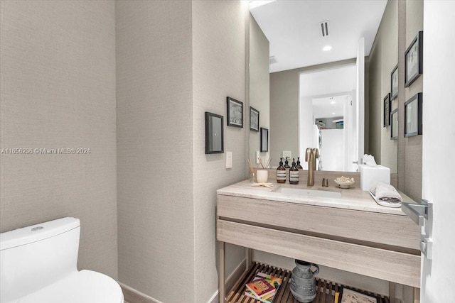 bathroom with visible vents, toilet, and vanity