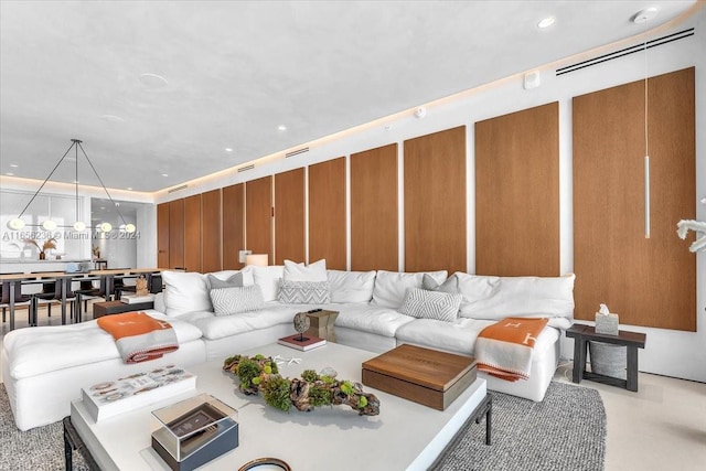 living room with recessed lighting and a chandelier