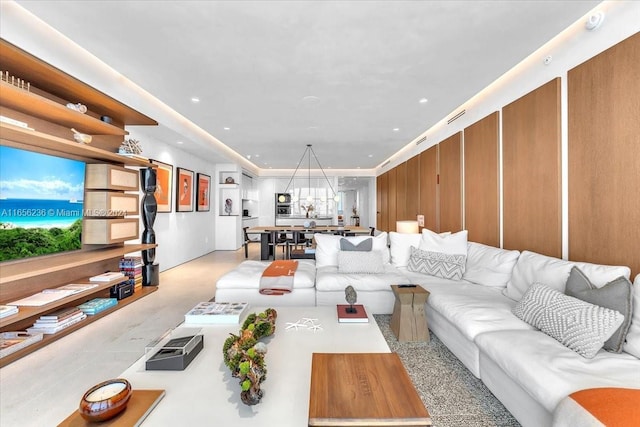 living area featuring visible vents, recessed lighting, and finished concrete flooring