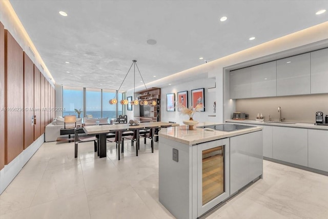 kitchen featuring white cabinetry, beverage cooler, modern cabinets, and expansive windows