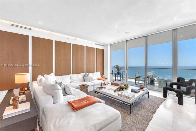 tiled living area featuring floor to ceiling windows and a water view