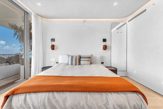 bedroom featuring light wood-type flooring and multiple windows