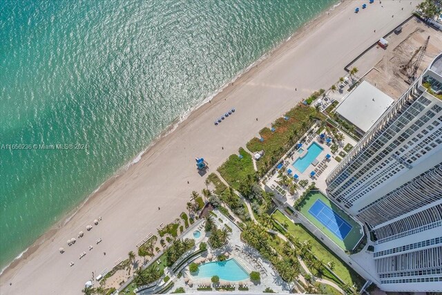 bird's eye view with a water view and a view of the beach