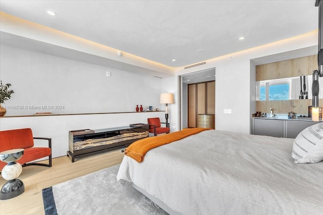 bedroom featuring recessed lighting and wood finished floors