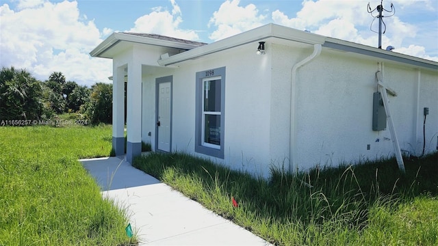 view of property exterior featuring a lawn