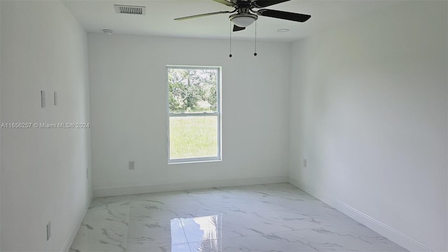 empty room with a wealth of natural light and ceiling fan