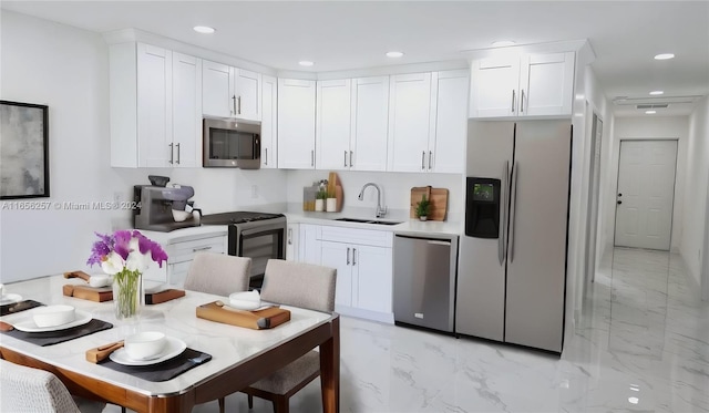 kitchen featuring stainless steel appliances, sink, and white cabinetry