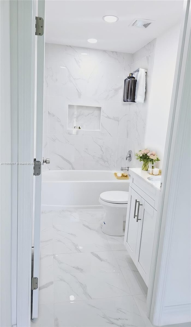 full bathroom featuring vanity, toilet, and tiled shower / bath combo