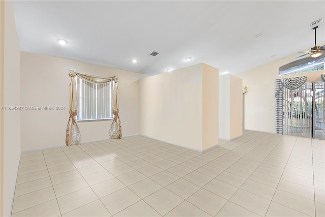 tiled empty room featuring ceiling fan