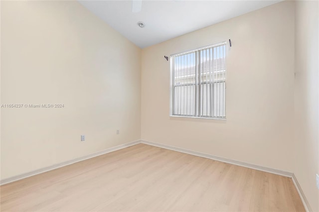 unfurnished room with vaulted ceiling and light hardwood / wood-style floors