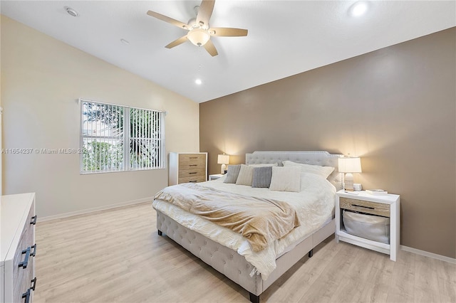 bedroom featuring light hardwood / wood-style flooring, ceiling fan, and vaulted ceiling