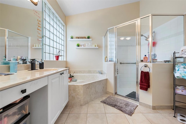 bathroom featuring vanity, shower with separate bathtub, and tile patterned floors