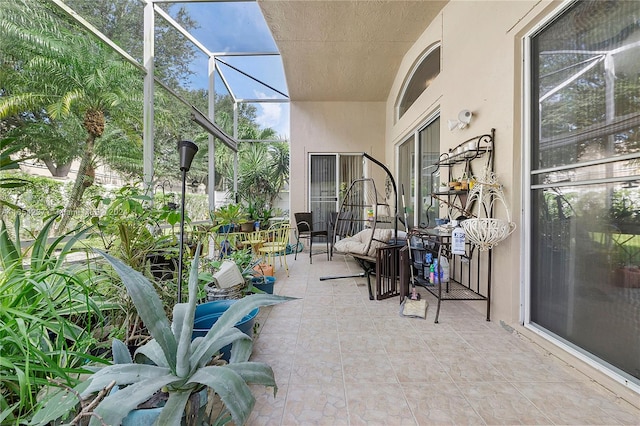 view of patio with glass enclosure