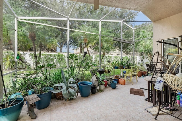 view of patio featuring glass enclosure