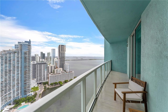 balcony featuring a view of city and a water view