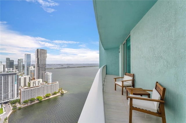 balcony featuring a view of city and a water view