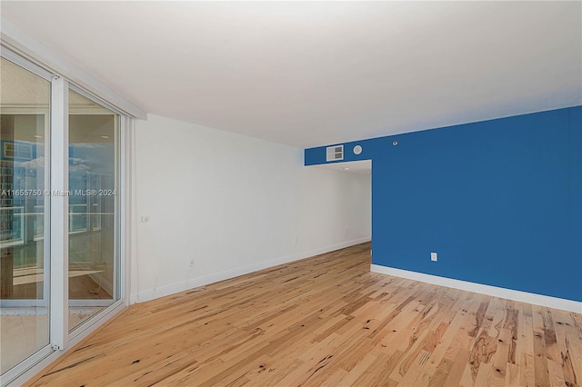 spare room featuring wood-type flooring