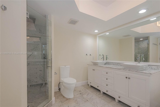 bathroom featuring walk in shower, toilet, and vanity