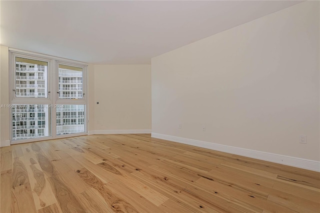 spare room with light hardwood / wood-style flooring