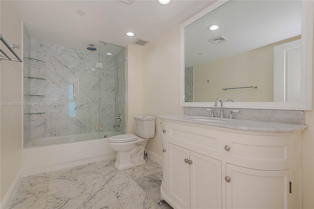 full bathroom featuring tiled shower / bath, vanity, and toilet