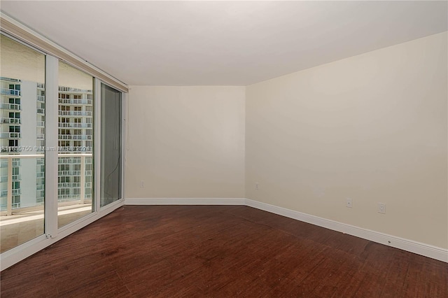 spare room featuring dark wood-type flooring