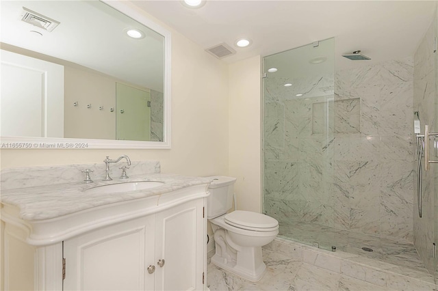 bathroom with vanity, toilet, and walk in shower