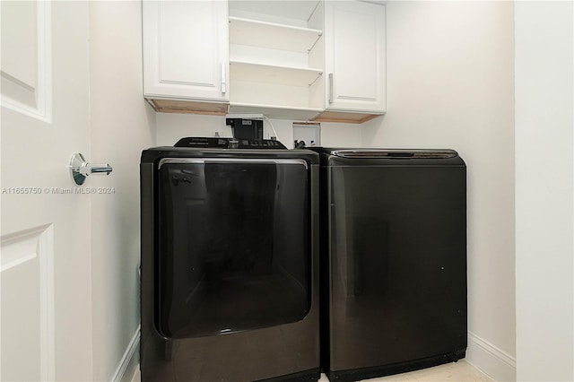 laundry area with cabinets and separate washer and dryer