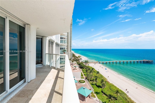 balcony with a beach view and a water view