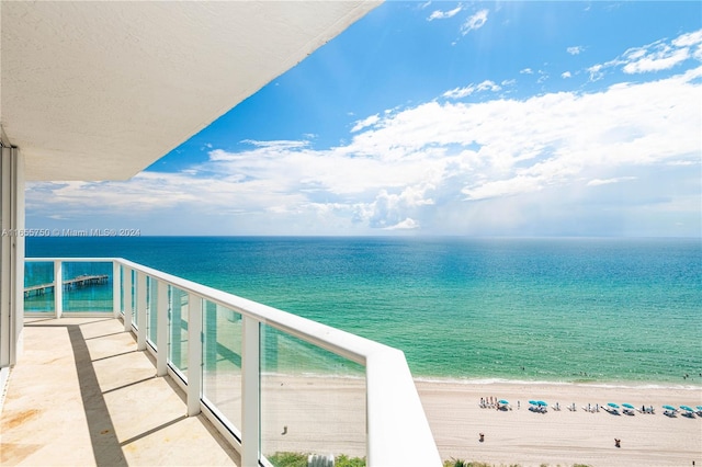 balcony with a view of the beach and a water view