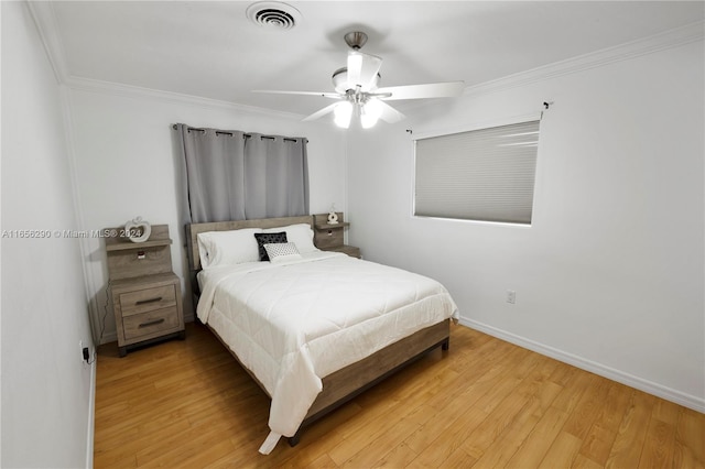 bedroom featuring crown molding, ceiling fan, and light wood-type flooring