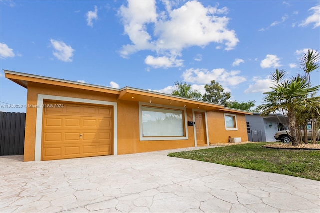 view of front of home featuring a garage and a front lawn