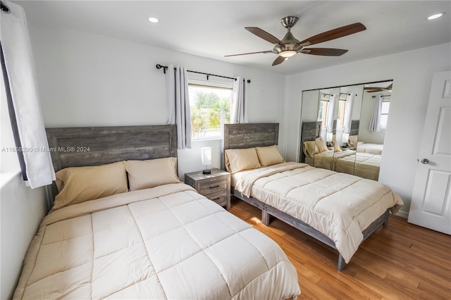 bedroom with ceiling fan, a closet, and light hardwood / wood-style floors