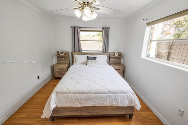 bedroom featuring crown molding, ceiling fan, and light hardwood / wood-style floors