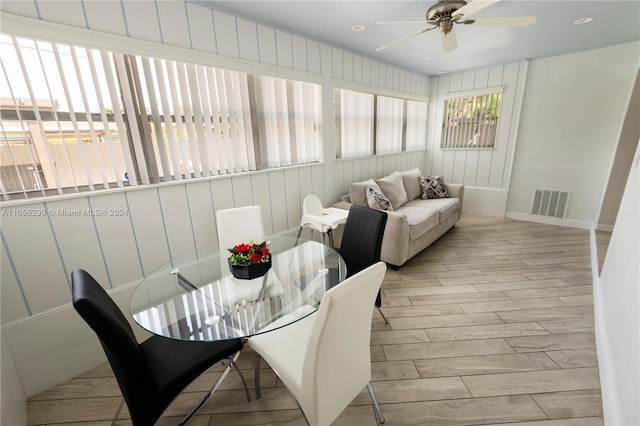 sunroom featuring ceiling fan