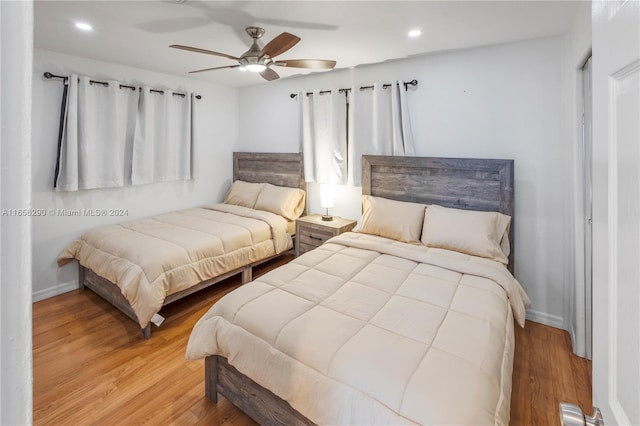 bedroom with light hardwood / wood-style flooring and ceiling fan