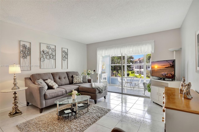 living room with a textured ceiling and light tile patterned floors