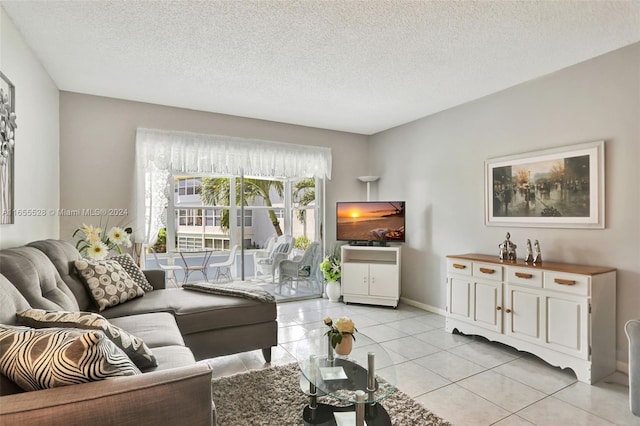 living room featuring a textured ceiling and light tile patterned floors