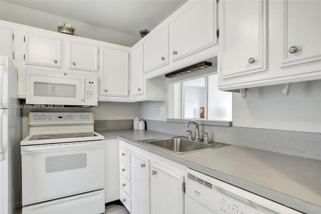 kitchen featuring white appliances, white cabinetry, and sink