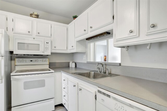 3501 NW 47th Ave Unit 516, Lauderdale Lakes, FL 33319 - kitchen with white appliances, a sink, and white cabinets