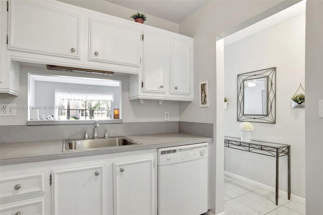 3501 NW 47th Ave Unit 516, Lauderdale Lakes, FL 33319 - kitchen featuring dishwasher, a sink, white cabinets, light countertops, and light tile patterned floors