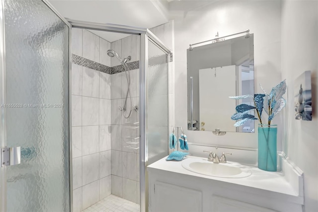 bathroom with vanity and a shower with door