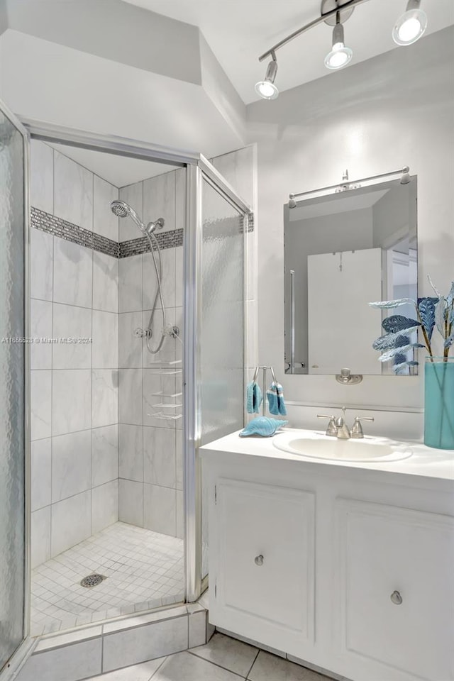 bathroom featuring vanity, an enclosed shower, and tile patterned flooring