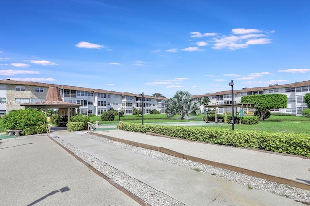 surrounding community with a lawn and a gazebo