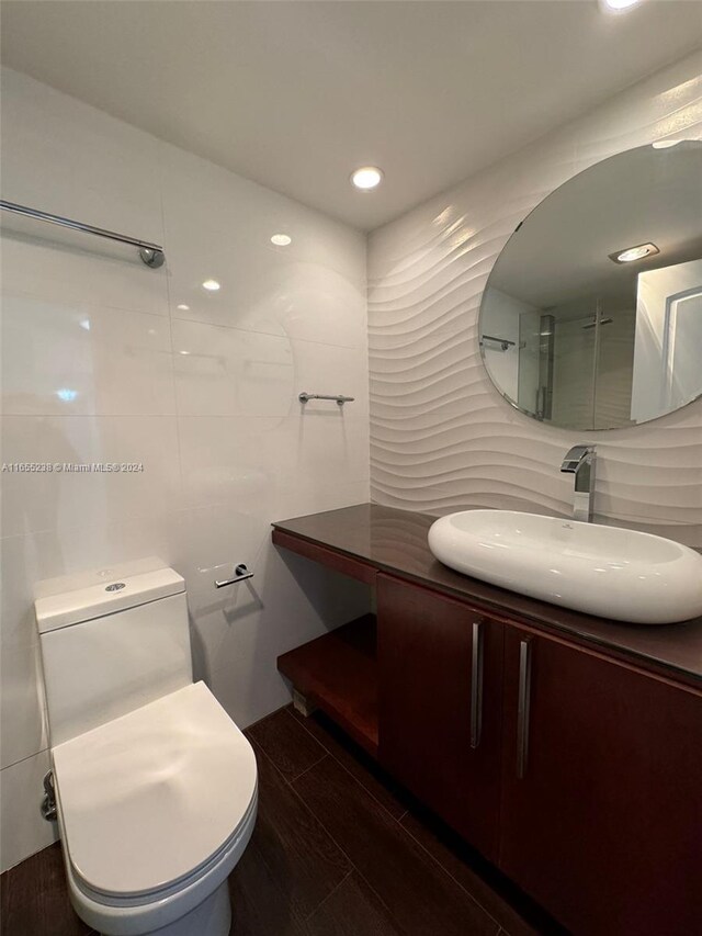 bathroom featuring vanity, toilet, and hardwood / wood-style flooring