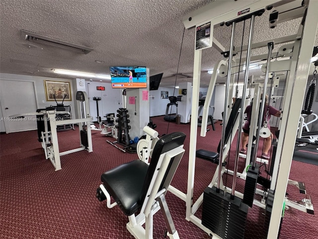 gym featuring a textured ceiling